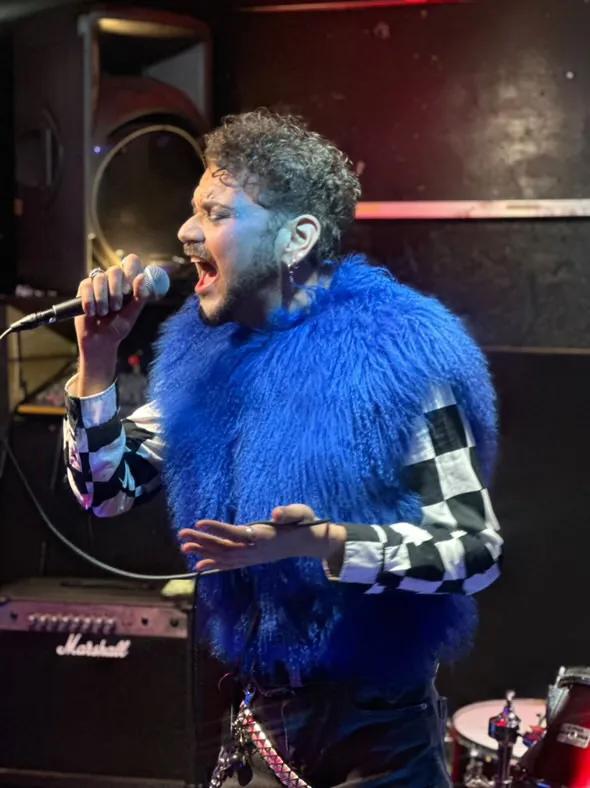 Ebro performing live, microphone in hand